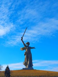 Low angle view of statue against blue sky