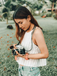 Young woman photographing camera