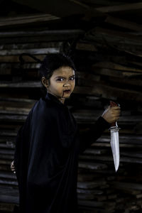 Portrait of young woman standing outdoors