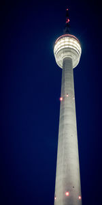 Low angle view of communications tower against clear sky at night