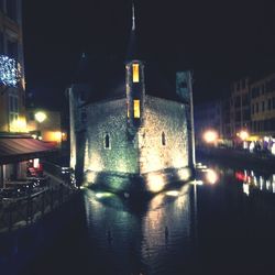 Illuminated city against sky at night