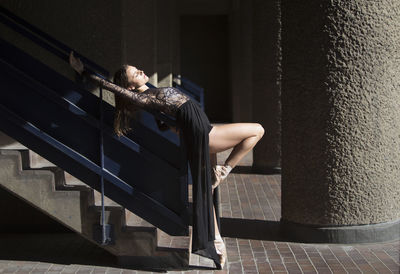 Woman sitting on staircase