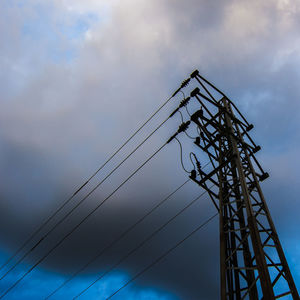 Low angle view of cables against sky