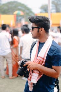 Young man photographing camera