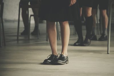 Low section of students standing in classroom