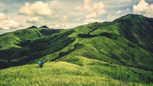 Scenic view of green landscape against sky