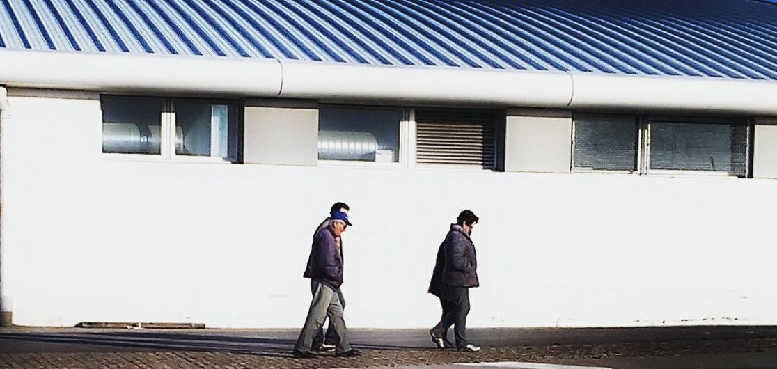 lifestyles, full length, leisure activity, casual clothing, rear view, walking, men, built structure, architecture, togetherness, person, building exterior, standing, bonding, street, day, boys