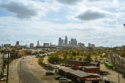 Aerial view of buildings in city against sky