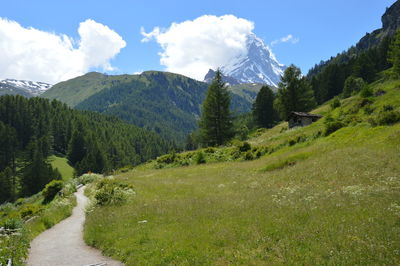 Scenic view of mountain range against cloudy sky