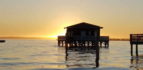 Scenic view of sea against orange sky