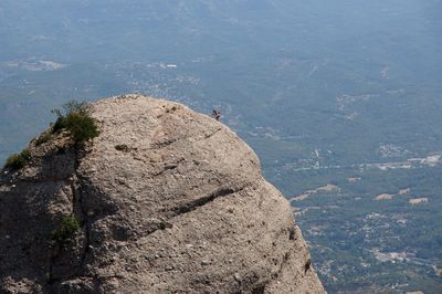 High angle view of hiker climbing on mountain