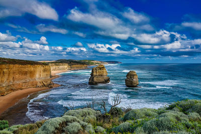 View of rocks in sea against sky