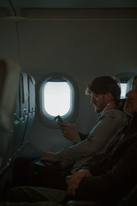 Rear view of man sitting in bus