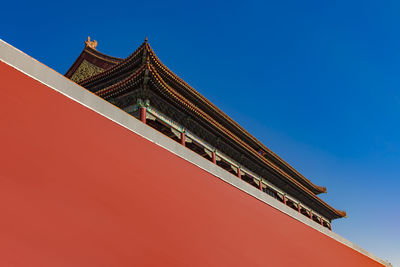 Low angle view of building against clear blue sky