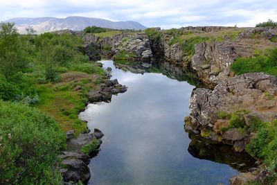 Scenic view of trees and mountains against sky
