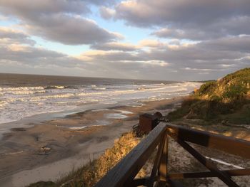 View of beach against cloudy sky