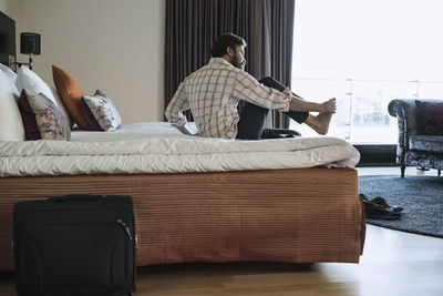 Businessman relaxing in hotel room