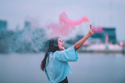 Man smoking against sky