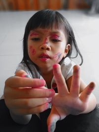 Portrait of a smiling girl holding camera