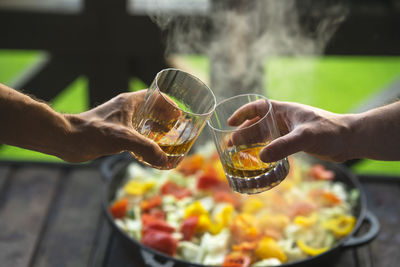 Two men drinking whiskey at the party at home