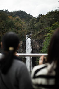 Rear view of people standing on mountain