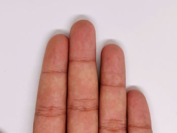 Close-up of hand against white background