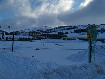 Snow covered field against sky