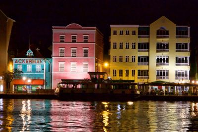 Reflection of illuminated buildings in canal at night