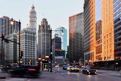 View of city street and buildings at night