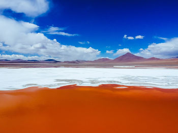 Scenic view of mountains against blue sky