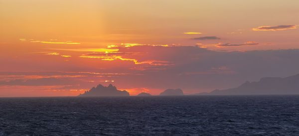 Scenic view of sea against orange sky