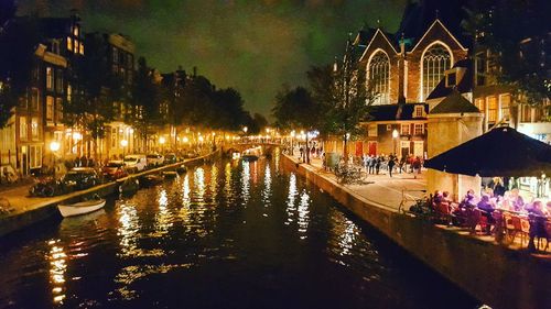 Reflection of people in water at night