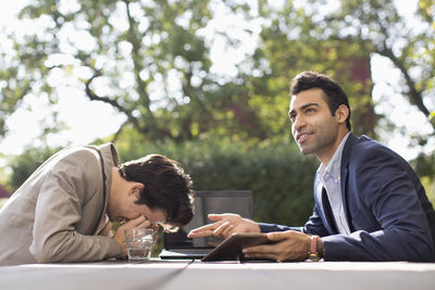 Confused businessmen being stumbled at outdoor cafe