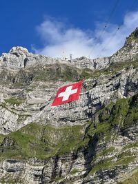 Low angle view of flag against mountain