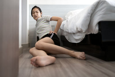 Midsection of woman sitting at home