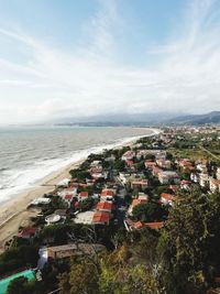 High angle view of townscape by sea against sky