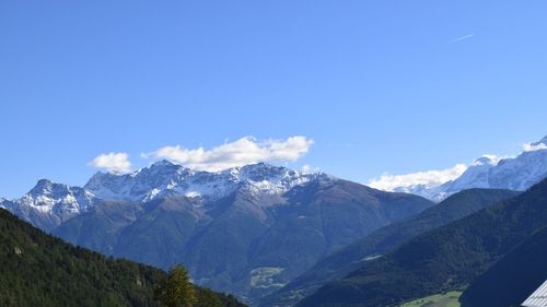 Scenic view of mountains against blue sky