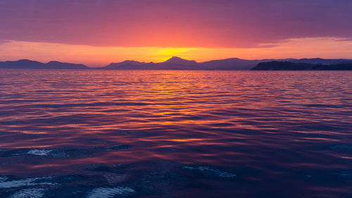 Scenic view of sea against romantic sky at sunset