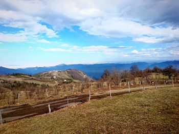 Scenic view of farm against sky