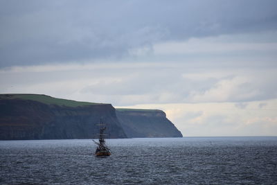 Sailboat on sea against sky