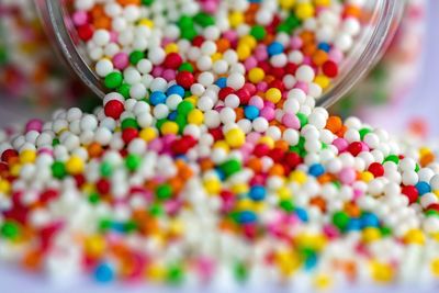 Close-up of colorful sprinkles by jar