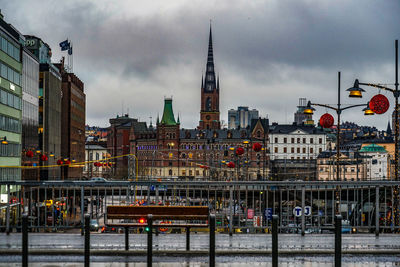 Bridge over river against buildings in city