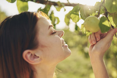 Close-up portrait of woman with fruits