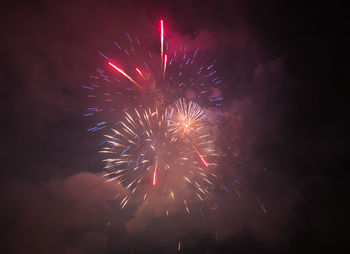Low angle view of firework display at night