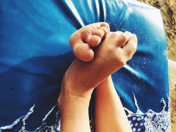 Close-up of hand holding blue water