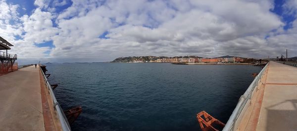 Panoramic view of sea and buildings against sky