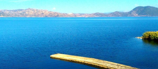 Scenic view of sea against blue sky