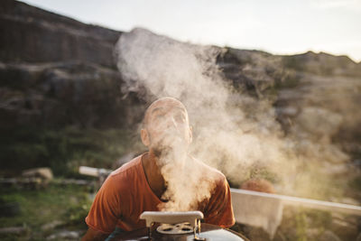 Man looking at camera on land