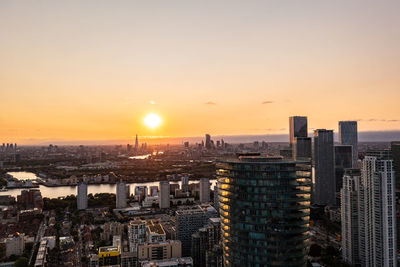 High angle view of city buildings against sky during sunset