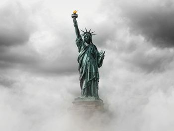 Low angle view of statue against cloudy sky